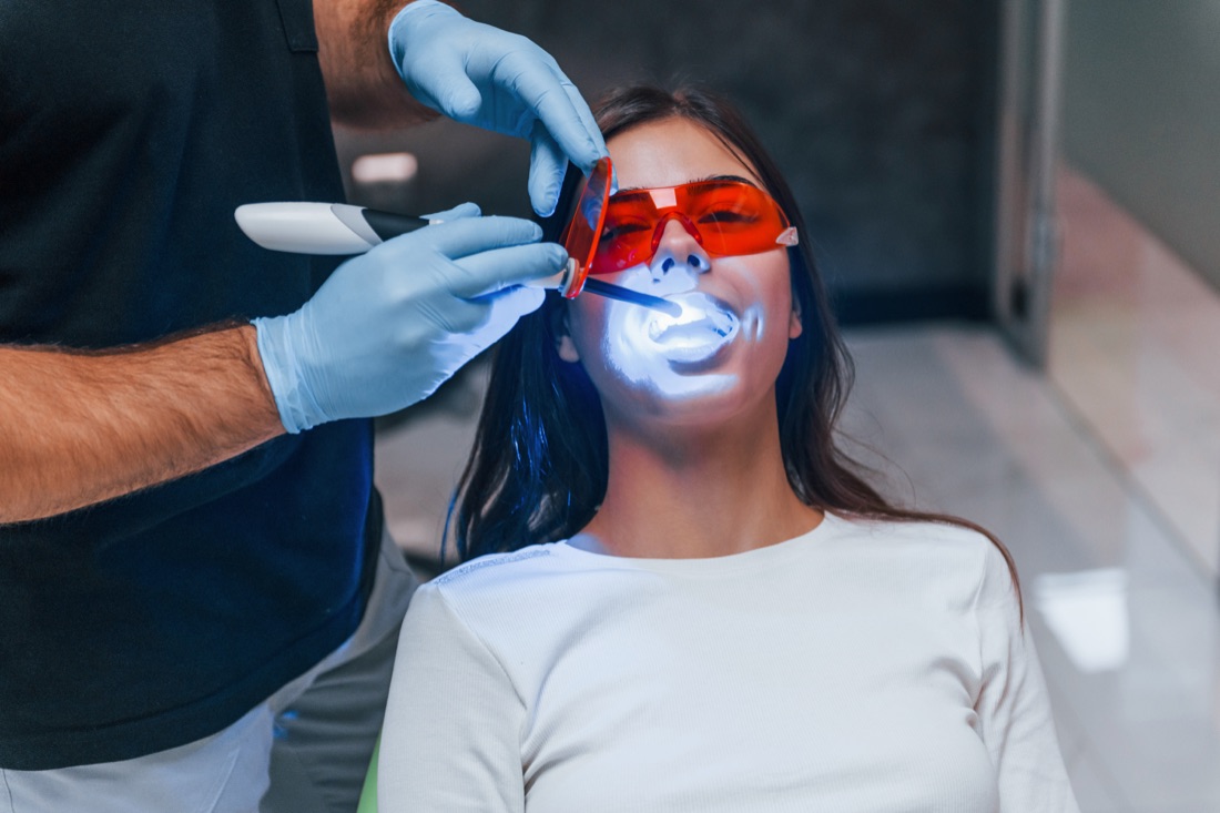 Patient receiving professional teeth whitening treatment in Riverside